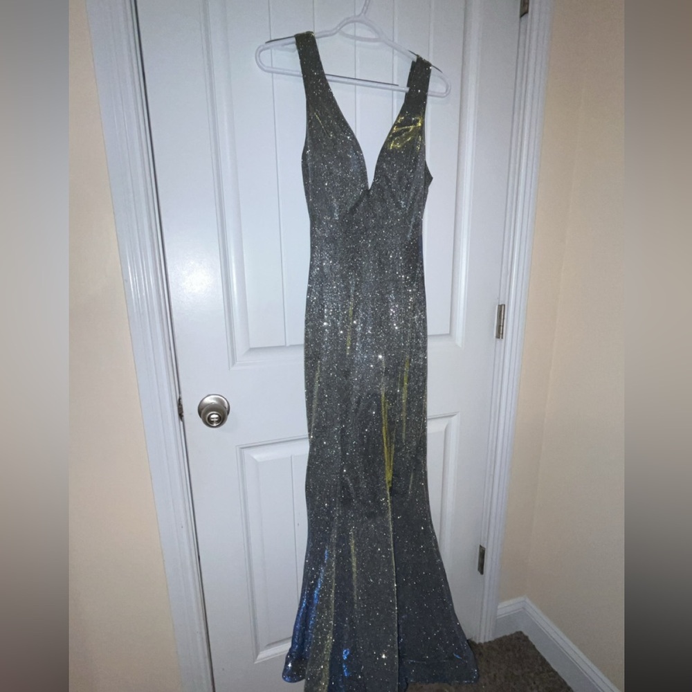 It’s an iridescent gown only worn once. It’s a size 3